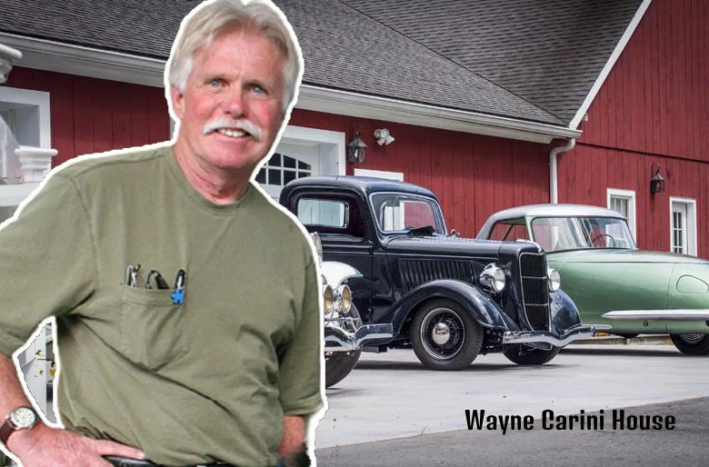 Wayne Carini standing outside his iconic Portland, Connecticut house with vintage cars on display.
