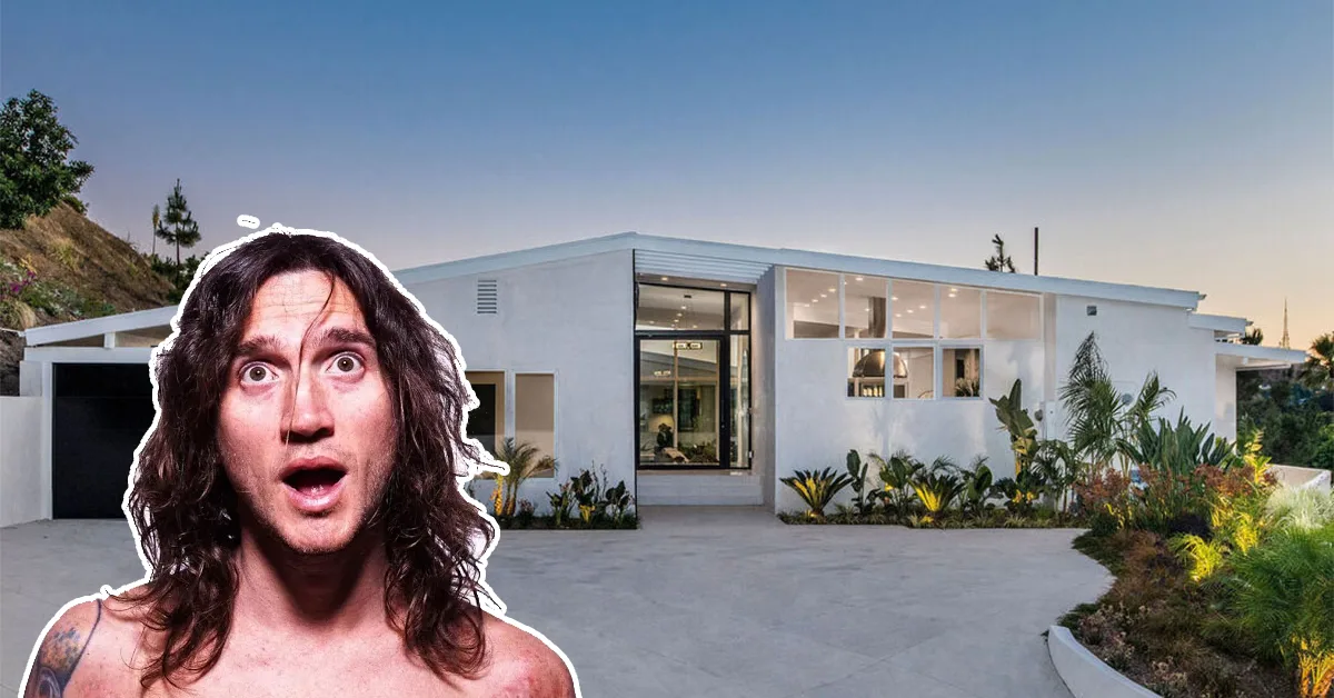 Front view of the modern John Frusciante House in the Hollywood Hills, showcasing its sleek architecture and lush landscaping at sunset.