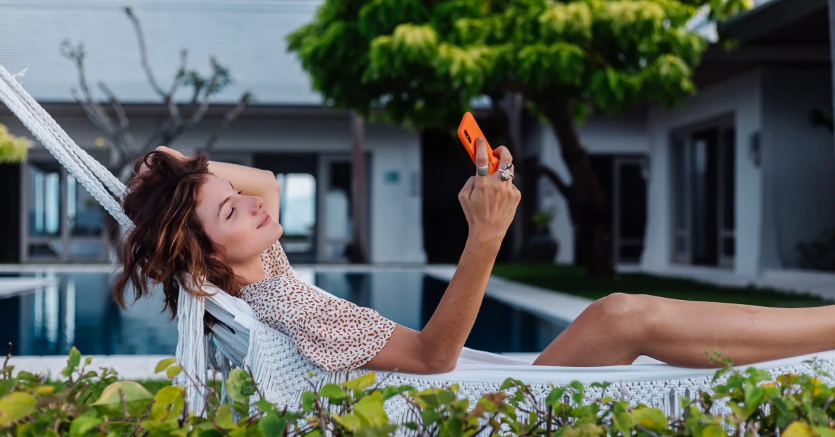 Woman relaxing in hammock enjoying summer home cooling hacks for comfortable outdoor living