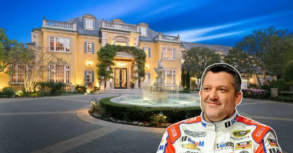 Aerial view of Tony Stewart House Hidden Hollow Ranch luxury log mansion with 9-acre lake and 415 acres in Columbus, Indiana featuring rustic lodge architecture.